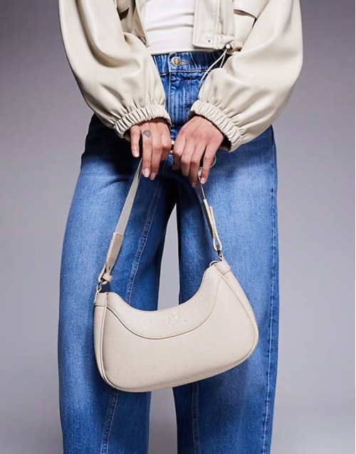 curved logo shoulder bag in cream